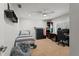 Bright room featuring a single bed, a fan, a desk with a computer, and other assorted items at 17311 Carriage Way, Odessa, FL 33556