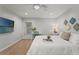 Bright bedroom with a white bed, desk, and TV at 17311 Carriage Way, Odessa, FL 33556
