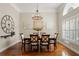 Dining room with hardwood floors, chandelier, and large windows providing natural light at 17311 Carriage Way, Odessa, FL 33556