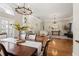 Elegant dining area adjacent to the living room with stylish lighting and ample natural light at 17311 Carriage Way, Odessa, FL 33556