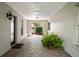 Welcoming entryway features brick flooring, a decorative light fixture and an inviting fern at 17311 Carriage Way, Odessa, FL 33556
