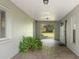 Covered walkway leading to the front door, featuring decorative pavers and lush greenery at 17311 Carriage Way, Odessa, FL 33556