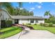 Well-maintained single-story home with a lush front yard, manicured landscaping, and a paved walkway at 17311 Carriage Way, Odessa, FL 33556