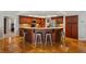 Well-equipped kitchen with dark wood cabinetry, granite countertops, and stainless steel appliances at 17311 Carriage Way, Odessa, FL 33556