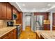 Spacious kitchen features stainless steel appliances, granite countertops, and custom wood cabinets at 17311 Carriage Way, Odessa, FL 33556