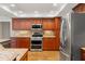 Gourmet kitchen with granite countertops, stainless steel appliances, and ample cabinet space at 17311 Carriage Way, Odessa, FL 33556