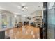Open-concept living area with hardwood floors, French doors, and a view of the kitchen with a breakfast bar at 17311 Carriage Way, Odessa, FL 33556