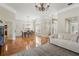 Spacious living room with hardwood floors, neutral walls, and a view into the dining area at 17311 Carriage Way, Odessa, FL 33556