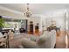Living room featuring hardwood floors, chandelier, neutral paint, and access to the screened-in pool area at 17311 Carriage Way, Odessa, FL 33556