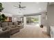 Spacious living room with a fireplace and access to the outdoor pool area at 17311 Carriage Way, Odessa, FL 33556