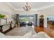 Open living area with hardwood flooring, stylish decor, and a view of the pool area through sliding glass doors at 17311 Carriage Way, Odessa, FL 33556