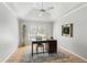 Bright office with neutral colors, desk, and a large window at 17311 Carriage Way, Odessa, FL 33556