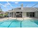 Gorgeous pool with a screened enclosure and an outdoor kitchen area, perfect for entertaining at 17311 Carriage Way, Odessa, FL 33556
