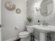 Stylish powder room featuring marble tile, modern fixtures, and elegant decor, perfect for guests at 17311 Carriage Way, Odessa, FL 33556