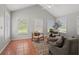 Bright sunroom with tile flooring, vaulted ceilings, and multiple windows overlooking the yard at 17311 Carriage Way, Odessa, FL 33556