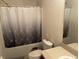 Bathroom featuring a shower/tub combo and a modern gray shower curtain at 1941 Greenwood Valley Dr, Plant City, FL 33563
