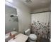 Cozy bathroom featuring a shower/tub combo and a white floral shower curtain at 1941 Greenwood Valley Dr, Plant City, FL 33563