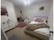 Bedroom features a large bed with headboard lighting and a vanity desk at 1941 Greenwood Valley Dr, Plant City, FL 33563