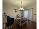 Bright dining area with a wood table, bench seating, and stylish chandelier at 1941 Greenwood Valley Dr, Plant City, FL 33563
