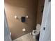 Simple and functional half-bath with toilet, towel bar, and tiled floor at 1941 Greenwood Valley Dr, Plant City, FL 33563