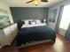 Bright main bedroom featuring wood-look floors, neutral paint and a ceiling fan at 1941 Greenwood Valley Dr, Plant City, FL 33563