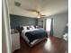 Spacious main bedroom with a ceiling fan, wood-look floors, and a large window at 1941 Greenwood Valley Dr, Plant City, FL 33563