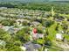 Drone shot of neighborhood featuring this house nestled in green trees with nearby community amenities at 2535 Regal River Rd, Valrico, FL 33596