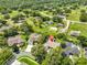 Aerial view of property showing the surrounding neighborhood with mature trees and green lawns at 2535 Regal River Rd, Valrico, FL 33596