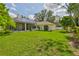 Spacious backyard featuring a well-maintained lawn, solar panels, and a screened-in patio at 2535 Regal River Rd, Valrico, FL 33596