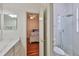 Bathroom opens to a bedroom with matching bath features and tiled walk-in shower at 2535 Regal River Rd, Valrico, FL 33596