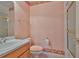 Bathroom with a vanity, toilet, and shower-tub combo featuring neutral decor and a patterned border at 2535 Regal River Rd, Valrico, FL 33596