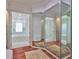 Bright bathroom entryway features a three-way mirror and view to soaking tub and tiled shower at 2535 Regal River Rd, Valrico, FL 33596