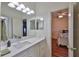Bathroom with white marble countertop and view to bedroom with matching decor and bedding at 2535 Regal River Rd, Valrico, FL 33596