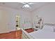 Bright bedroom with white furniture, ceiling fan, and wood-look floors creating a cozy atmosphere at 2535 Regal River Rd, Valrico, FL 33596