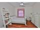 Bright bedroom has a matching desk, shelving, and white color scheme at 2535 Regal River Rd, Valrico, FL 33596