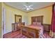 Bedroom with a large bed, wood furniture, a ceiling fan, and a decorative border creating a cozy space at 2535 Regal River Rd, Valrico, FL 33596