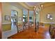 Dining area features hardwood floors, chandelier, and a view into the living space at 2535 Regal River Rd, Valrico, FL 33596