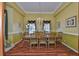 Formal dining room with hardwood floors, chandelier, and a large dining table at 2535 Regal River Rd, Valrico, FL 33596
