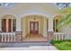 Inviting front porch showcasing stone accents, arched entryways, and a double-door entrance at 2535 Regal River Rd, Valrico, FL 33596