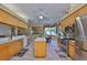 Well-lit kitchen features a center island, stainless steel appliances, and ample cabinet space at 2535 Regal River Rd, Valrico, FL 33596