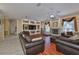 Spacious living room featuring hardwood floors, a fireplace, and plenty of natural light at 2535 Regal River Rd, Valrico, FL 33596