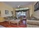 Comfortable living area with hardwood floors, large windows, and stylish decor at 2535 Regal River Rd, Valrico, FL 33596