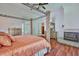 Spacious main bedroom features a fireplace, wood floors, and views into an ensuite bathroom at 2535 Regal River Rd, Valrico, FL 33596