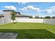 Spacious backyard featuring lush green grass, a white privacy fence, and ample room for outdoor activities at 288 Villa Corte Dr, Lutz, FL 33549
