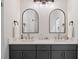 Bathroom features double sinks, quartz countertops, modern light fixtures, and decorative arched mirrors at 288 Villa Corte Dr, Lutz, FL 33549