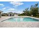 Refreshing community pool surrounded by a paved deck, offering a relaxing space for residents to enjoy at 288 Villa Corte Dr, Lutz, FL 33549