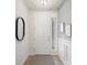 Bright foyer with a white front door, stylish mirror, and elegant wall trim, creating a welcoming entrance at 288 Villa Corte Dr, Lutz, FL 33549