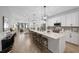 Spacious kitchen features a large island with seating, modern appliances, and pendant lighting open to the living room at 288 Villa Corte Dr, Lutz, FL 33549