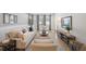 Bright living room featuring comfortable seating, a modern rug, and large windows that provide natural light at 288 Villa Corte Dr, Lutz, FL 33549