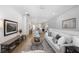 Open-concept living space with a neutral color palette, wood floors, and ample natural light, ideal for modern living at 288 Villa Corte Dr, Lutz, FL 33549